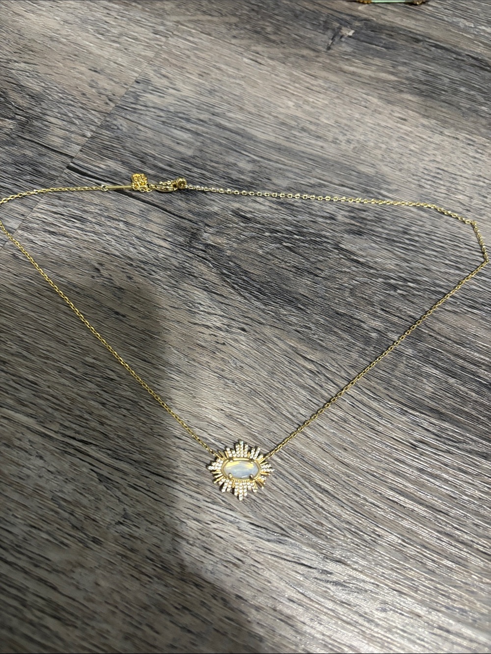 Kendra Scott Gold Sunburst Necklace with White Opal Stone